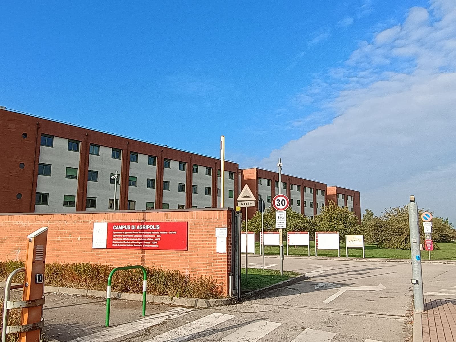 The gate of the Agripolis campus, with its red sign